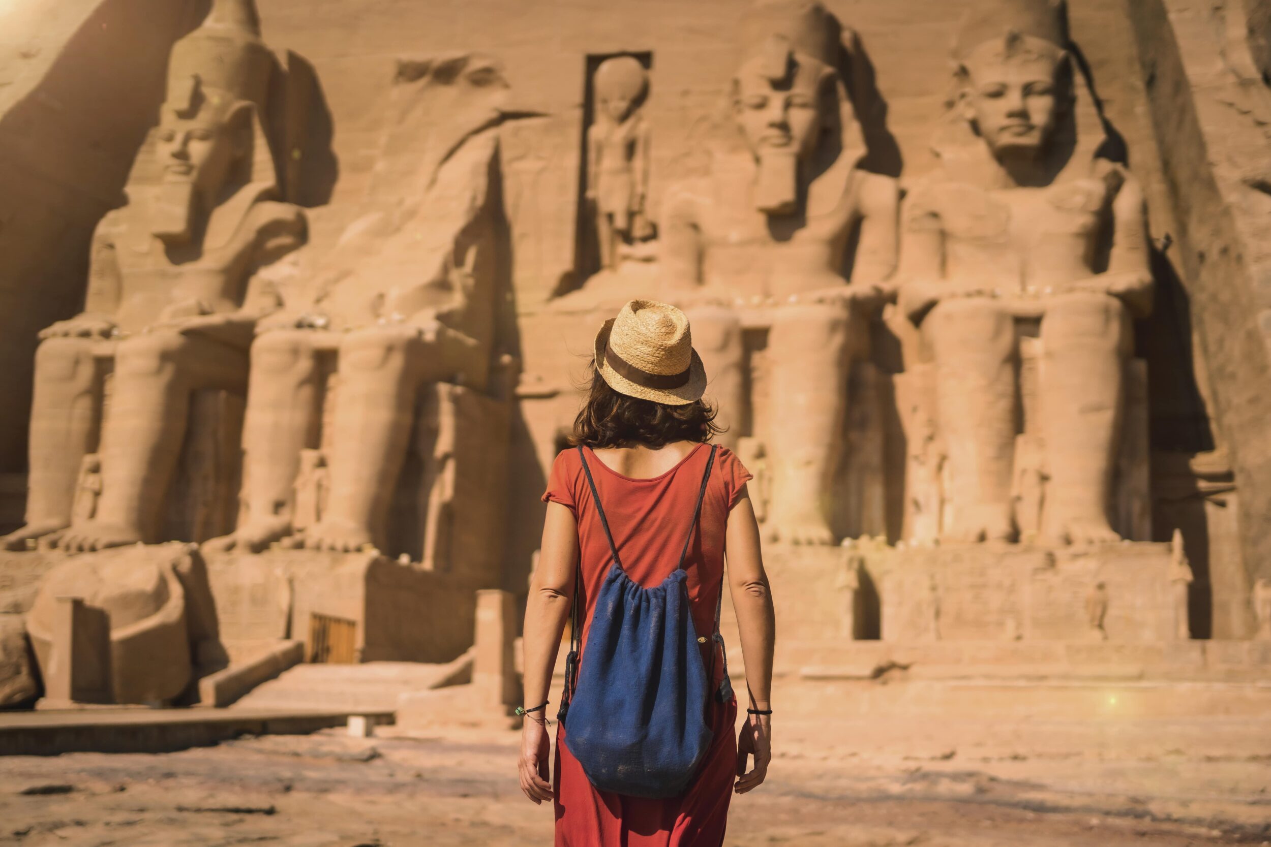 a-young-tourist-in-a-red-dress-entering-the-abu-si-2024-12-10-01-59-21-utc-min