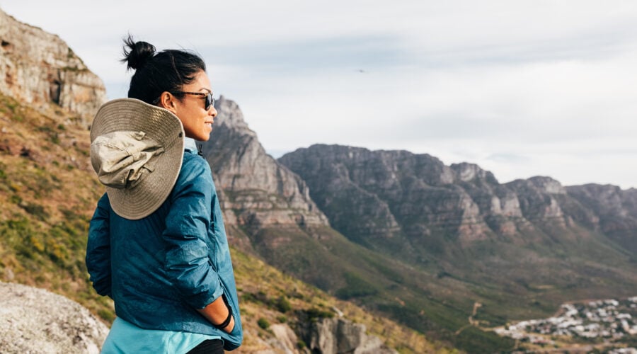 Back view of a woman wearing glasses looking at the view. Female